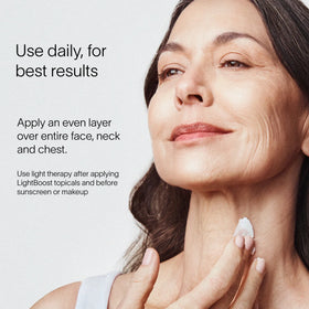A woman applies LightBoost Face & Neck Rich Cream to her face, smiling slightly. The text reads: For best results, use daily. Apply evenly over face, neck, and chest. Use light therapy after applying Solawaves LightBoost topicals and before sunscreen or makeup.