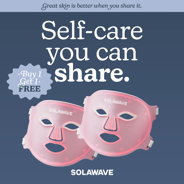 Two pink Solawave Wrinkle Retreat Pro LED Face Masks with eye, nose, and mouth cutouts are shown against a blue background. Text highlights self-care, anti-aging benefits, and a Buy 1 Get 1 Free offer using red, infrared, deep red & amber light.