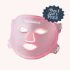 The Solawave Wrinkle Retreat Pro LED Face Mask with red, infrared, deep red, and amber light therapy is shown in pink with cutouts for the eyes, nose, and mouth. A "Buy 1 Get 1 Free" sticker appears on top right. White side straps complete the anti-aging design.